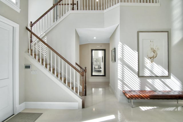 tiled foyer entrance with a high ceiling