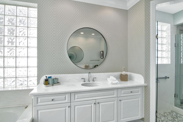 bathroom with ornamental molding, vanity, and shower with separate bathtub