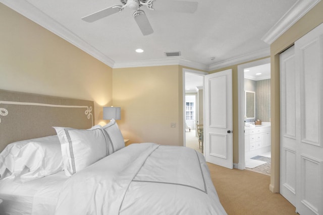 bedroom with crown molding, light colored carpet, ceiling fan, and ensuite bathroom