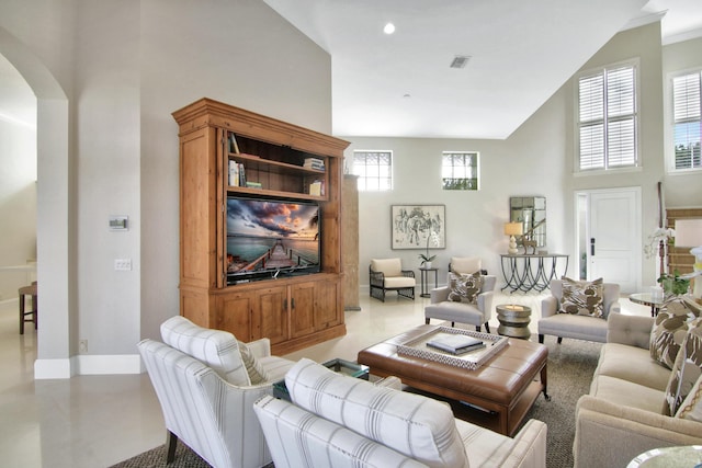 living room featuring a towering ceiling