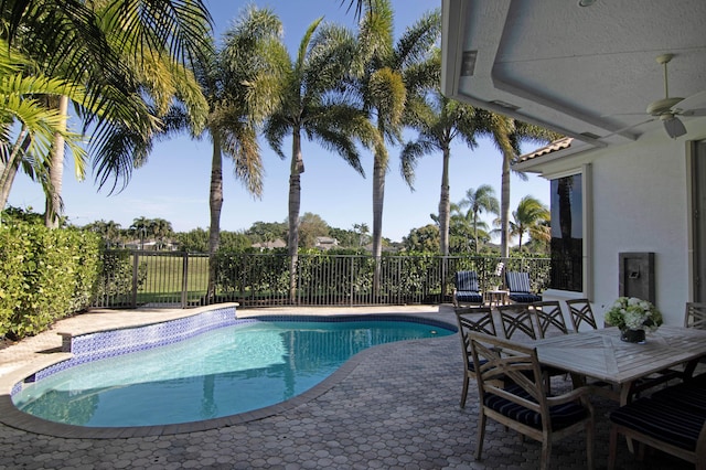 view of swimming pool with ceiling fan and a patio