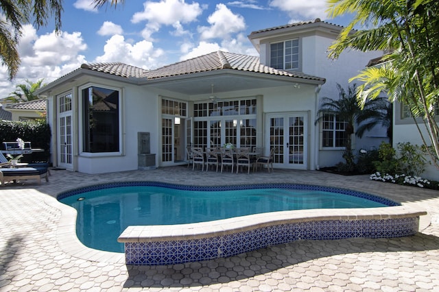 view of swimming pool featuring a patio area, french doors, and ceiling fan