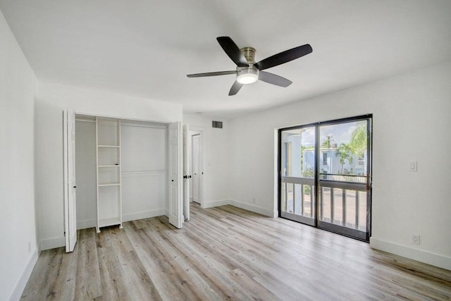 unfurnished bedroom featuring access to outside, ceiling fan, a closet, and light wood-type flooring