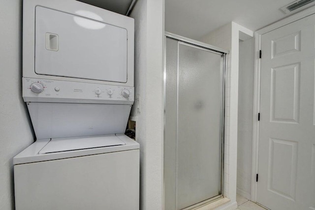 laundry area featuring stacked washing maching and dryer