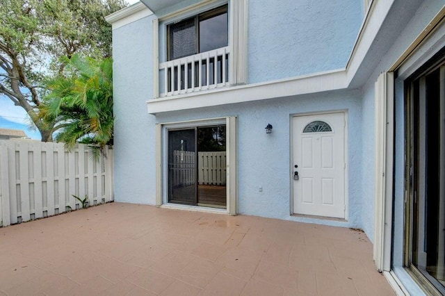 property entrance featuring a patio area