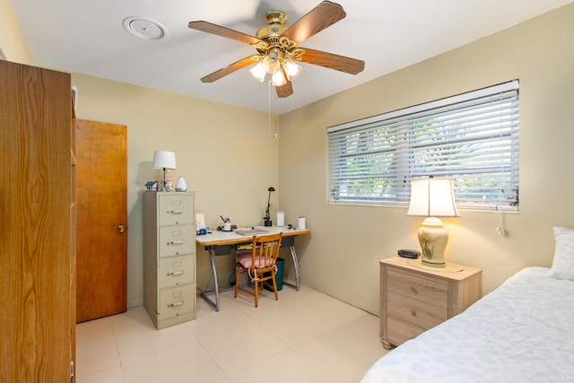 bedroom with ceiling fan and light tile patterned floors