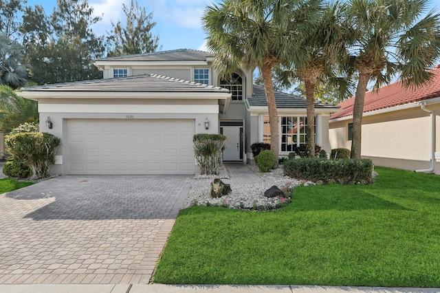 view of front facade featuring a front lawn and a garage