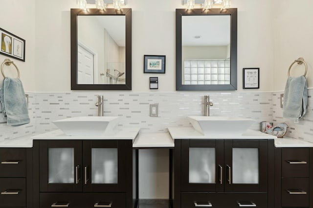 bathroom featuring vanity and backsplash