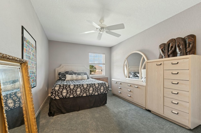 bedroom featuring ceiling fan, carpet floors, and a textured ceiling