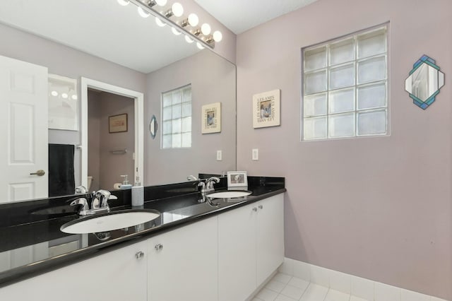 bathroom with tile patterned flooring, vanity, and toilet