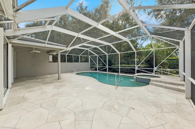 view of swimming pool featuring an in ground hot tub, a patio, ceiling fan, and a lanai