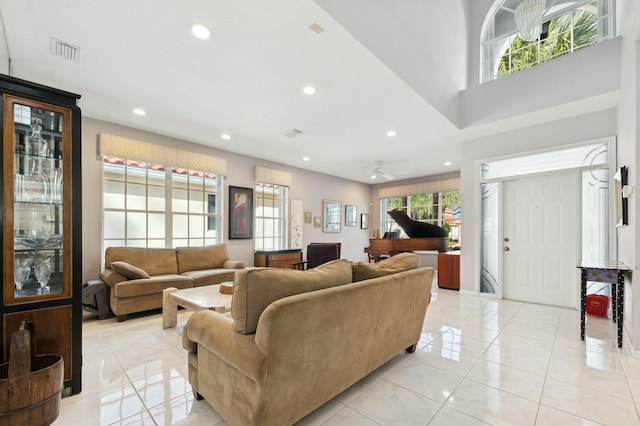 tiled living room with ceiling fan