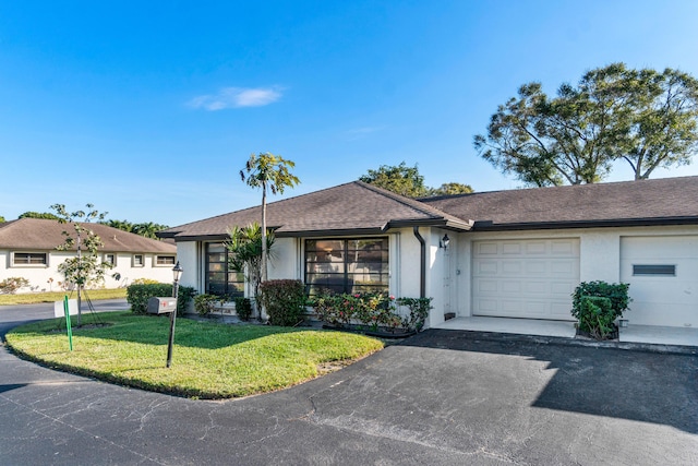 ranch-style house with a garage and a front yard