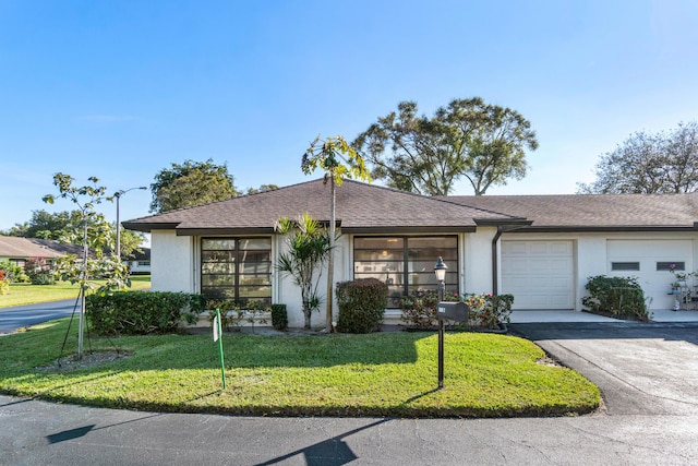 ranch-style house with a front yard and a garage