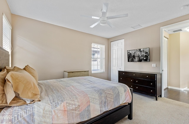 bedroom with ceiling fan and light carpet