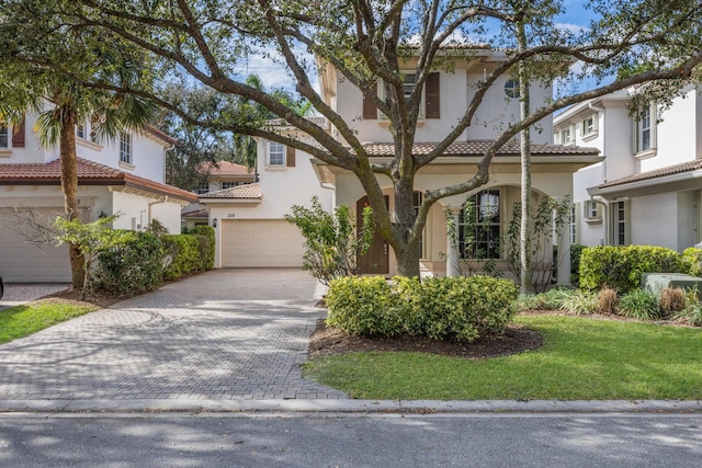 mediterranean / spanish-style house with a garage