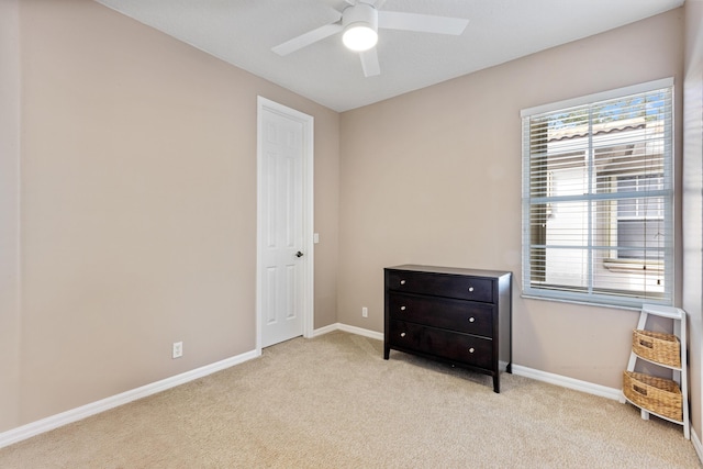 bedroom with ceiling fan and light carpet