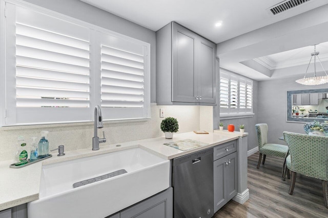 kitchen with visible vents, dishwasher, light countertops, gray cabinetry, and a sink