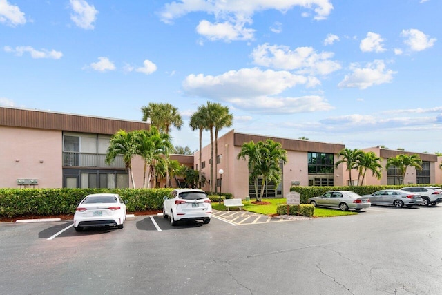 view of property featuring uncovered parking