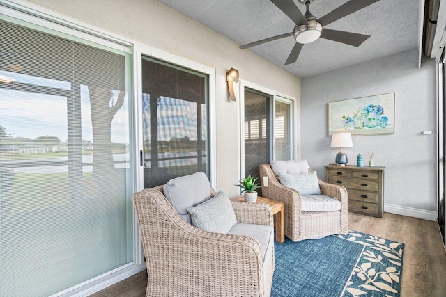 sunroom featuring ceiling fan