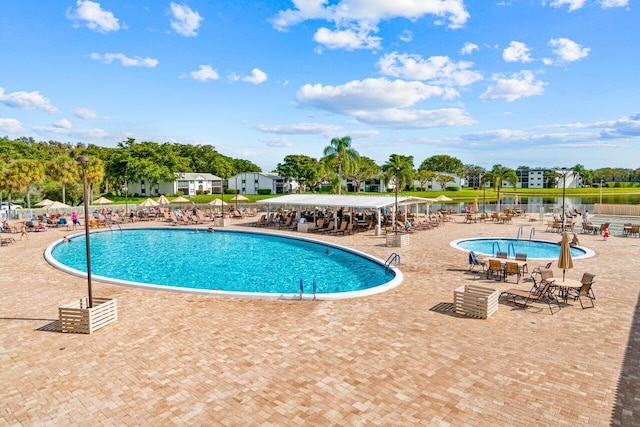 pool featuring fence and a patio