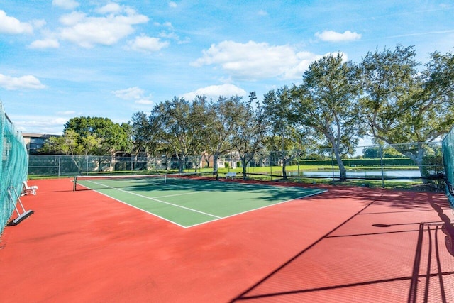 view of sport court featuring a water view, community basketball court, and fence