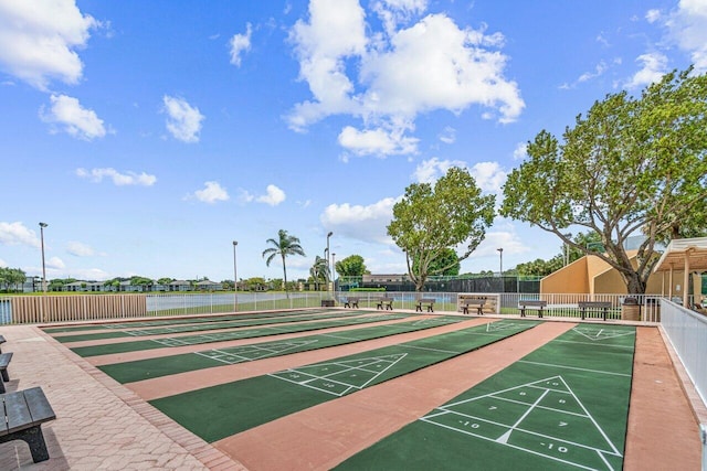 surrounding community featuring fence and shuffleboard