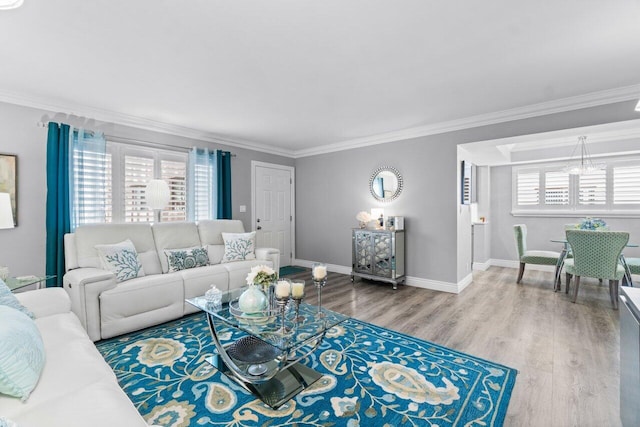 living room with baseboards, ornamental molding, and wood finished floors