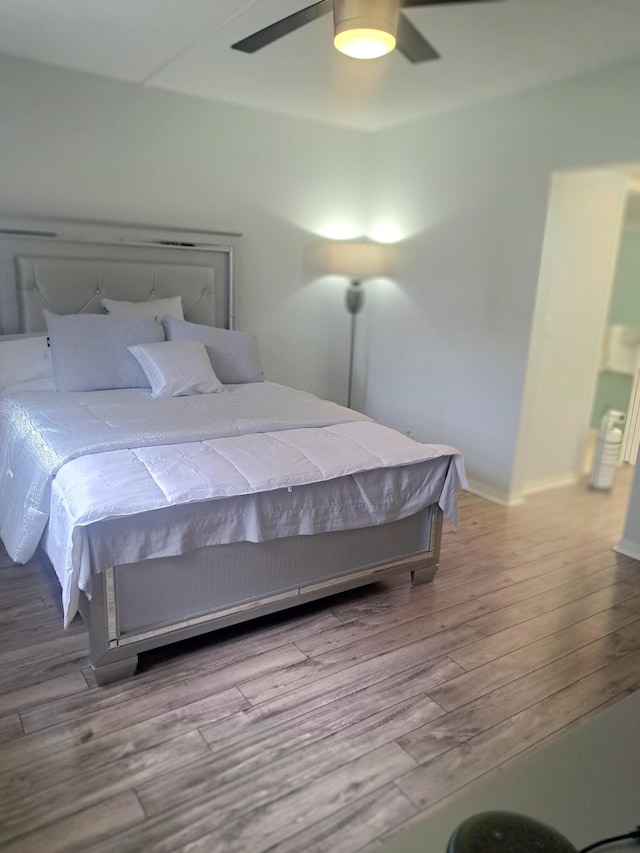 bedroom with light wood-type flooring and ceiling fan