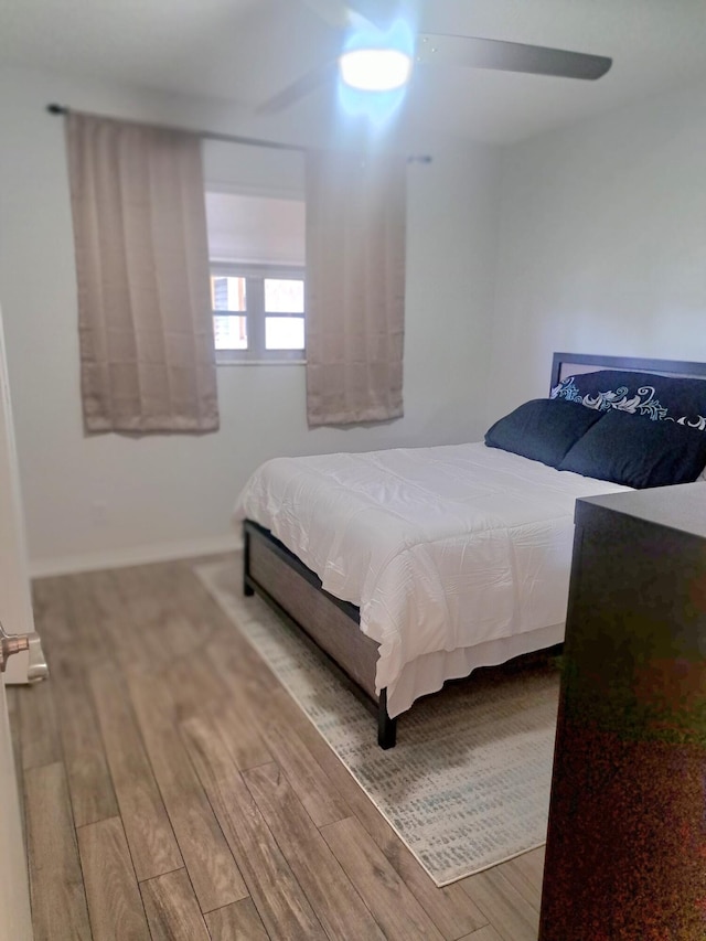 bedroom with ceiling fan and wood-type flooring