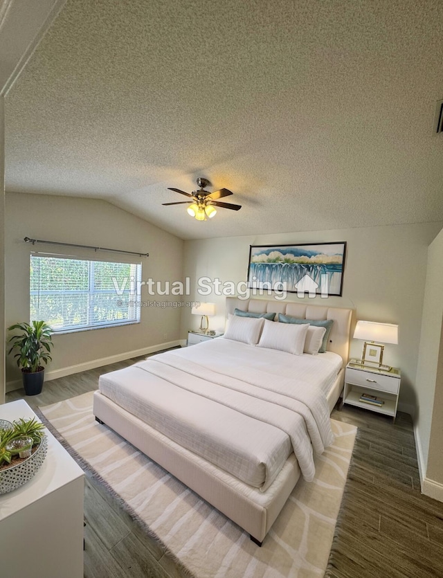 bedroom featuring a textured ceiling, ceiling fan, dark wood-type flooring, and lofted ceiling