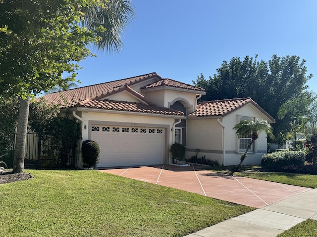 mediterranean / spanish home with a front yard