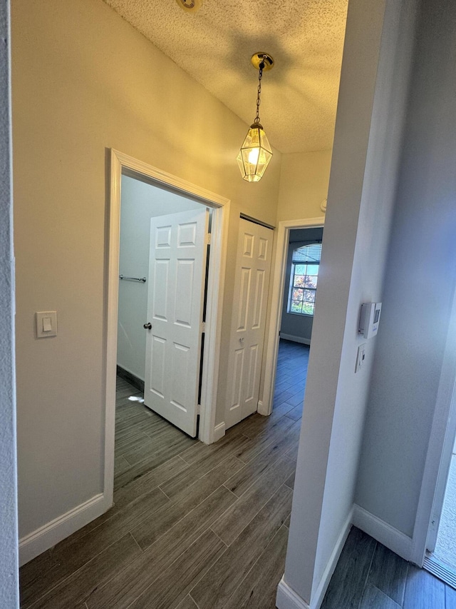 corridor featuring a textured ceiling