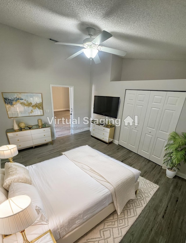 bedroom featuring a textured ceiling, ceiling fan, a high ceiling, dark hardwood / wood-style floors, and a closet