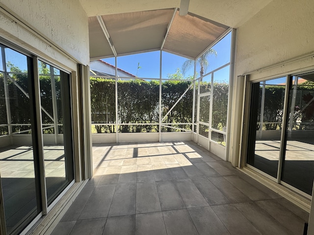 unfurnished sunroom with lofted ceiling