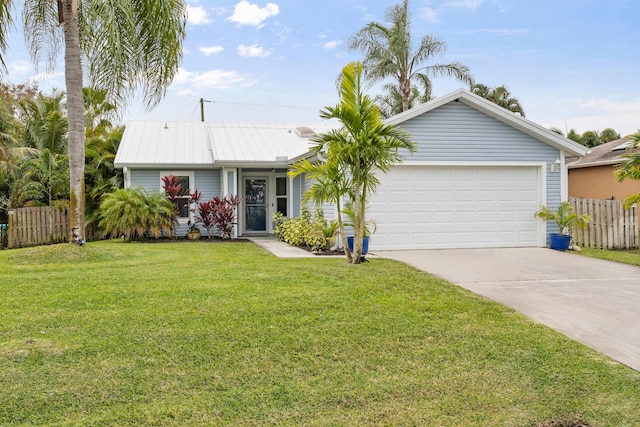 ranch-style house with concrete driveway, an attached garage, a front yard, fence, and metal roof