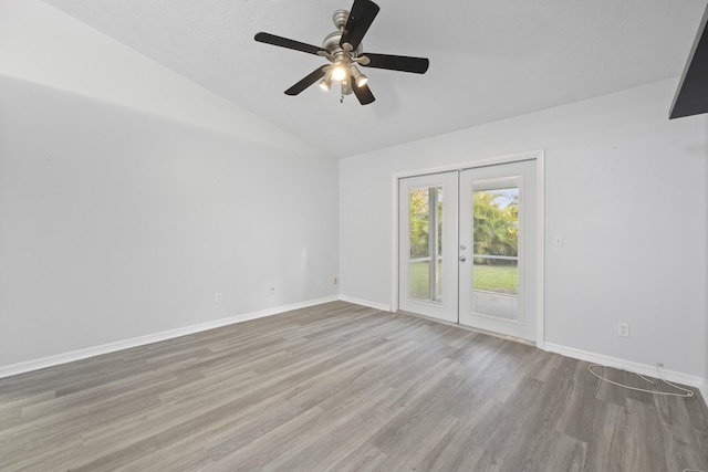 unfurnished room with ceiling fan, french doors, light hardwood / wood-style flooring, a textured ceiling, and vaulted ceiling