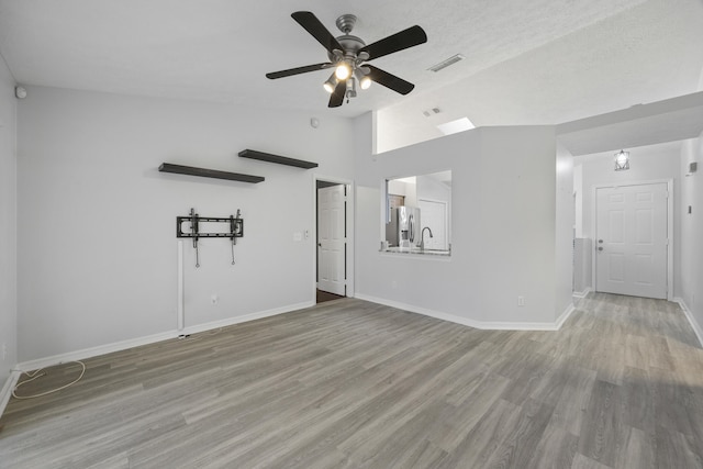 unfurnished room featuring lofted ceiling, visible vents, and wood finished floors