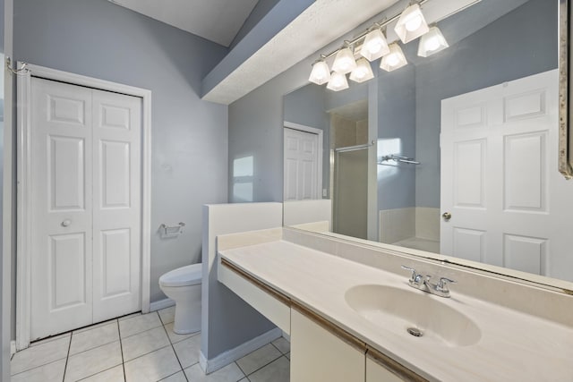 bathroom featuring tile patterned floors, vanity, toilet, and walk in shower