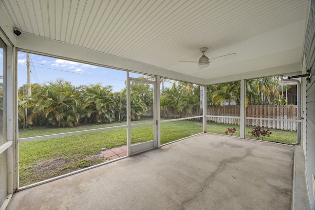 unfurnished sunroom featuring ceiling fan