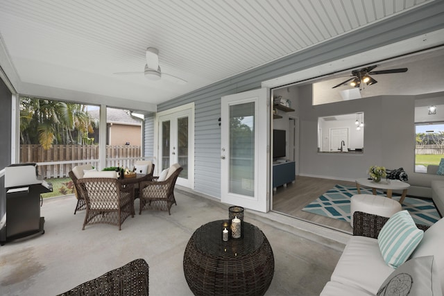 sunroom / solarium with french doors and ceiling fan