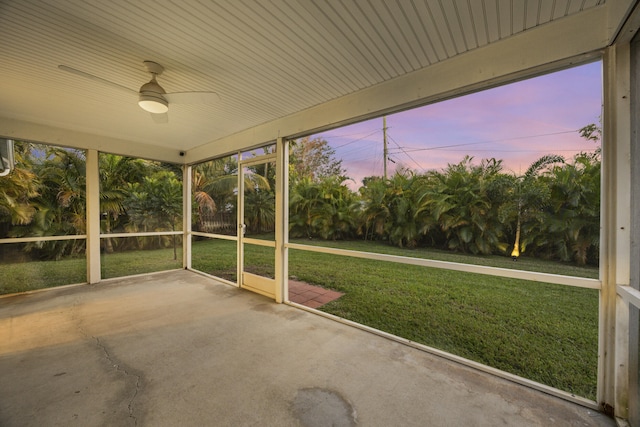 unfurnished sunroom with ceiling fan