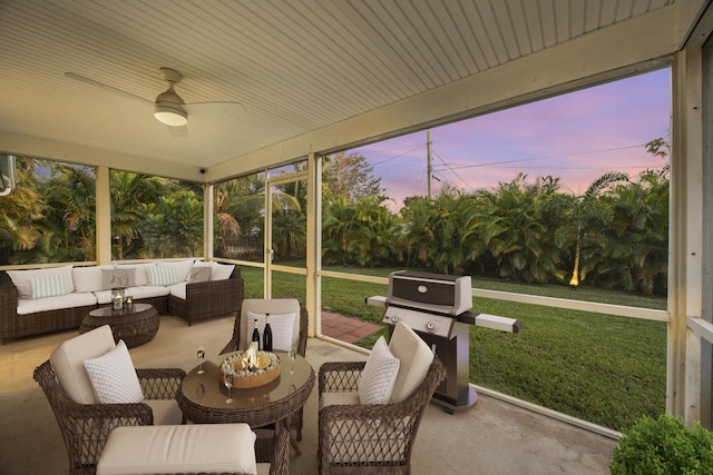 sunroom featuring ceiling fan