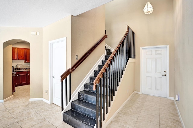 staircase with tile patterned floors