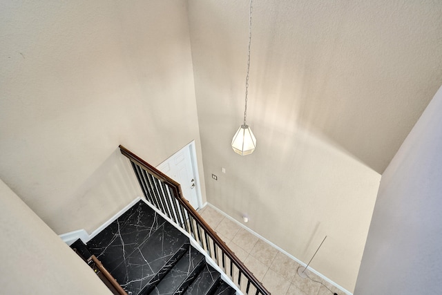 stairway featuring a high ceiling