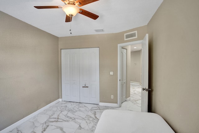 bedroom with ceiling fan and a closet