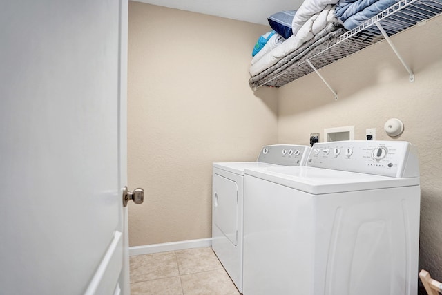 washroom with washer and dryer and light tile patterned floors