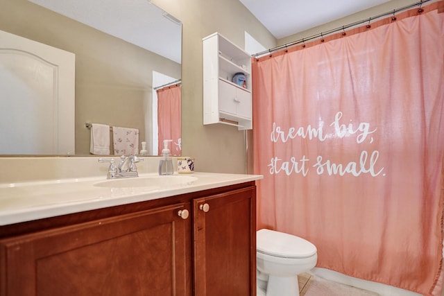 bathroom featuring tile patterned flooring, vanity, and toilet