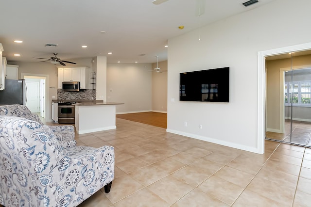 tiled living room featuring ceiling fan