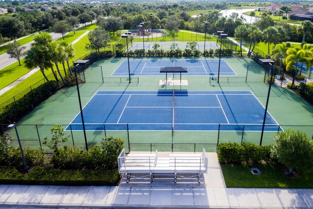 view of tennis court with basketball hoop